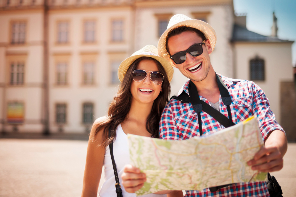 happy tourists couple holding map